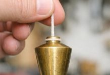 Found this heavy pointed brass weight in my dad’s old toolbox. It has a string attached. What is this?