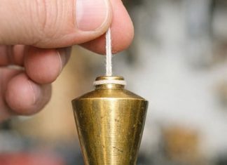 Found this heavy pointed brass weight in my dad’s old toolbox. It has a string attached. What is this?