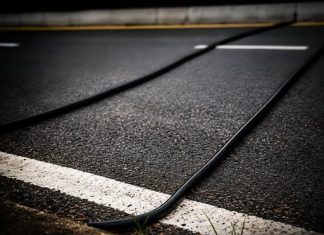 SPOTTED BLACK CABLES ON THE ROAD? HERE’S WHAT THEY ACTUALLY DO (AND WHAT YOU SHOULD NEVER DO)